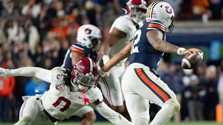 Nov 29, 2025; Auburn, Alabama, USA; Alabama linebacker Deontae Lawson (0) pressures Auburn quarterback Ashton Daniels (12) on the final play of the game at Jordan-Hare Stadium. Alabama defeated Auburn 27-20. Mandatory Credit: Gary Cosby Jr.-Tuscaloosa News