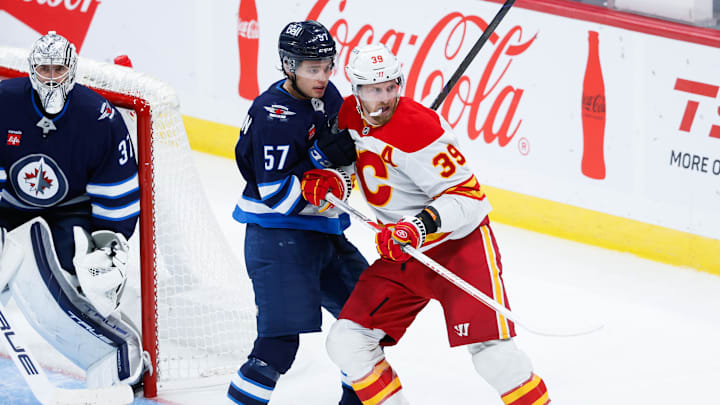 Oct 2, 2024; Winnipeg, Manitoba, CAN; Winnipeg Jets defenseman Elias Salomonsson (57) jostles for position with Calgary Flames forward Anthony Mantha (39) during the third period at Canada Life Centre. Mandatory Credit: Terrence Lee-Imagn Images Oct 2, 2024; Winnipeg, Manitoba, CAN; Winnipeg Jets defenseman Elias Salomonsson (57) jostles for position with Calgary Flames forward Anthony Mantha (39) during the third period at Canada Life Centre. Mandatory Credit: Terrence Lee-Imagn Images