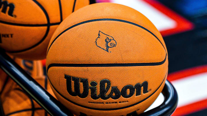 A basketball with the Louisville Cardinals logo in the center.