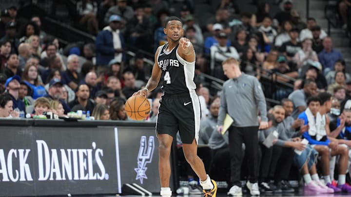 Mar 10, 2025; San Antonio, Texas, USA;  San Antonio Spurs guard De'Aaron Fox (4) points in the first half against the Dallas Mavericks at Frost Bank Center. Mandatory Credit: Daniel Dunn-Imagn Images