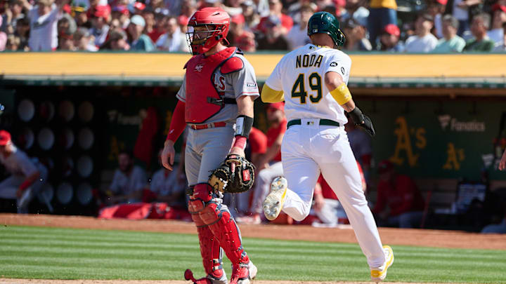 Sep 3, 2023; Oakland, California, USA; Oakland Athletics infielder Ryan Noda (49) scores a run against Los Angeles Angels catcher Chad Wallach (35) during the seventh inning at Oakland-Alameda County Coliseum. Mandatory Credit: Robert Edwards-Imagn Images