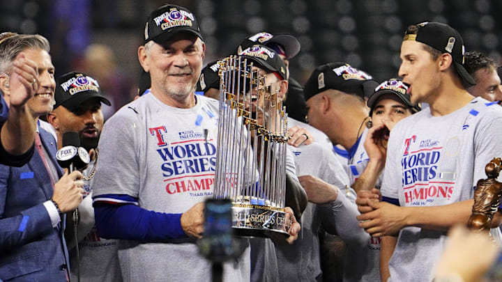 Texas Rangers manager Bruce Bochy celebrates with the Commissioners Trophy after the Texas Rangers
