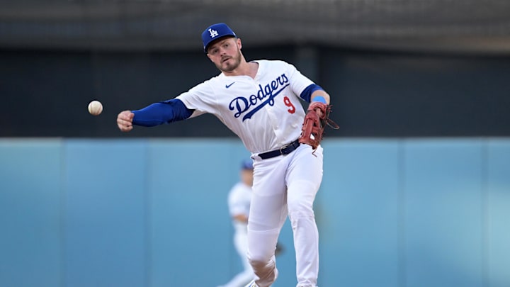 Oct 6, 2024; Los Angeles, California, USA; Los Angeles Dodgers second baseman Gavin Lux (9) throws out San Diego Padres first baseman Jake Cronenworth (9) in the second inning during game two of the NLDS for the 2024 MLB Playoffs at Dodger Stadium.