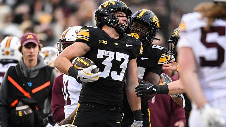 Oct 25, 2025; Iowa City, Iowa, USA; Iowa Hawkeyes linebacker Cam Buffington (33) reacts with wide receiver Apollo Payne (84) after an interception during the fourth quarter against the Minnesota Golden Gophers at Kinnick Stadium. Mandatory Credit: Jeffrey Becker-Imagn Images