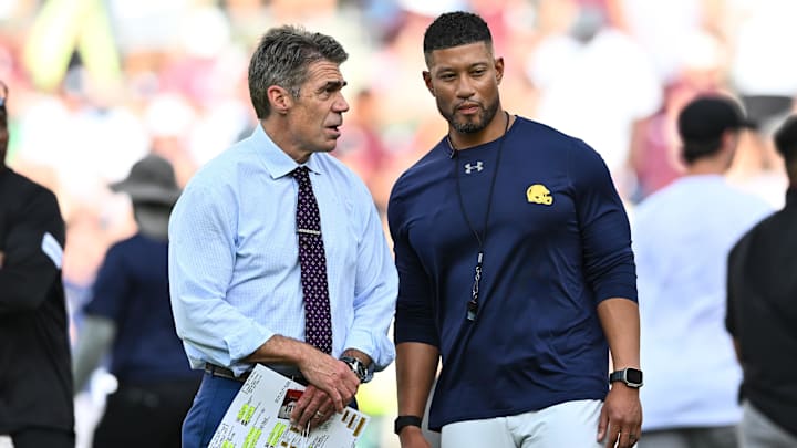 Chris Fowler a broadcaster for ESPN, left, speaks with Notre Dame Fighting Irish head coach Marcus Freeman