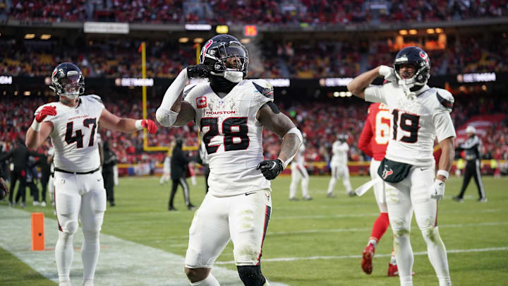 Jan 18, 2025; Kansas City, Missouri, USA; Houston Texans running back Joe Mixon (28) celebrates with fullback Andrew Beck (47) and wide receiver Xavier Hutchinson (19) after scoring a touchdown against the Kansas City Chiefs during the third quarter of a 2025 AFC divisional round game at GEHA Field at Arrowhead Stadium. Mandatory Credit: Denny Medley-Imagn Images