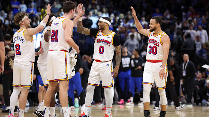 Feb 27, 2025; Orlando, Florida, USA; Golden State Warriors guard Stephen Curry (30) celebrates with guard Gary Payton II (0) center Quinten Post (21) after a play against the Orlando Magic in the fourth quarter at Kia Center. Mandatory Credit: Nathan Ray Seebeck-Imagn Images