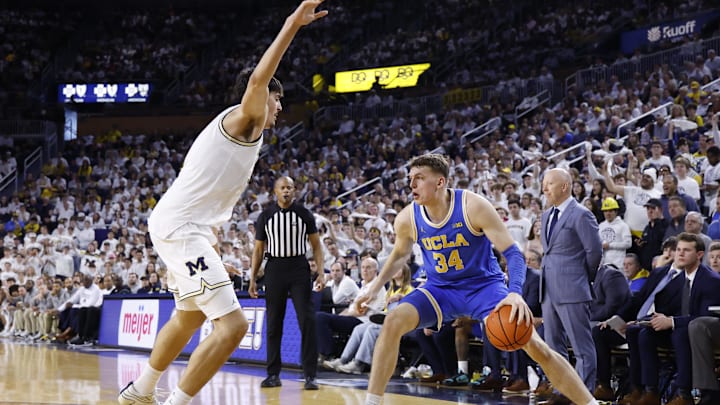 Feb 14, 2026; Ann Arbor, Michigan, USA; UCLA Bruins forward Tyler Bilodeau (34) is defended by Michigan Wolverines center Aday Mara (15) in the second half at Crisler Center. Mandatory Credit: Rick Osentoski-Imagn Images