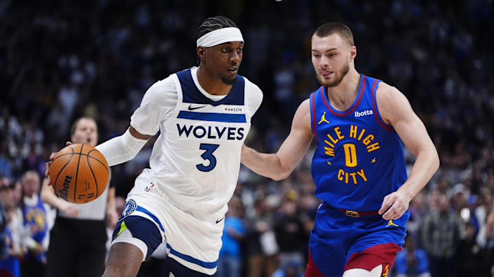 Mar 1, 2026; Denver, Colorado, USA; Denver Nuggets guard Christian Braun (0) defends on Minnesota Timberwolves forward Jaden McDaniels (3) in the first quarter at Ball Arena. Mandatory Credit: Ron Chenoy-Imagn Images