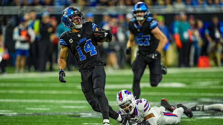 Detroit Lions wide receiver Amon-Ra St. Brown (14) avoids the tackle and runs for a first down during the second half at Ford Field in Detroit on Sunday, Dec. 15, 2024.