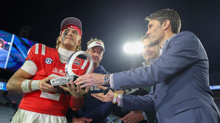 Jan 2, 2025; Jacksonville, FL, USA;  Mississippi Rebels quarterback Jaxson Dart (2) is given the MVP award after beating tubes Duke Blue Devils in the Gator Bowl at EverBank Stadium. Mandatory Credit: Nathan Ray Seebeck-Imagn Images