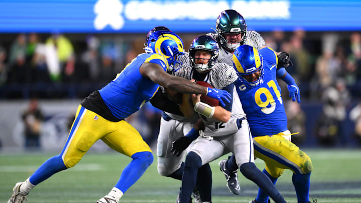 Dec 18, 2025; Seattle, Washington, USA; Los Angeles Rams linebacker Jared Verse (8) and defensive end Kobie Turner (91) sack Seattle Seahawks quarterback Sam Darnold (14) in the second half at Lumen Field. Mandatory Credit: Steven Bisig-Imagn Images
