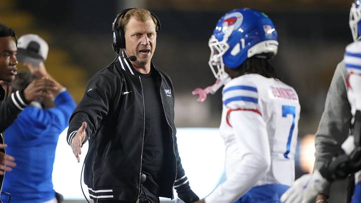 Nov 29, 2025; Berkeley, California, USA; Southern Methodist Mustangs quarterback Kevin Jennings (7) is congratulated by head coach Rhett Lashlee (center left) after scoring a touchdown against the California Golden Bears during the fourth quarter at California Memorial Stadium. Mandatory Credit: Darren Yamashita-Imagn Images