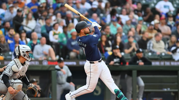 Jun 13, 2024; Seattle, Washington, USA; Seattle Mariners first baseman Tyler Locklear (27) hits a home run against the Chicago White Sox during the fifth inning at T-Mobile Park. Mandatory Credit: Steven Bisig-Imagn Images