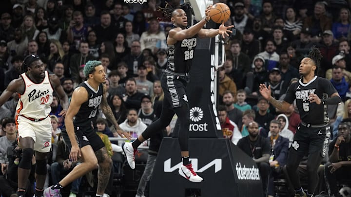 Feb 21, 2025; Austin, Texas, USA; San Antonio Spurs center Charles Bassey (28) reaches for a rebound over teammates forward Jeremy Sochan (10) and guard Stephon Castle (5) and Detroit Pistons forward Isaiah Stewart (28) during the first half at Moody Center. Mandatory Credit: Scott Wachter-Imagn Images