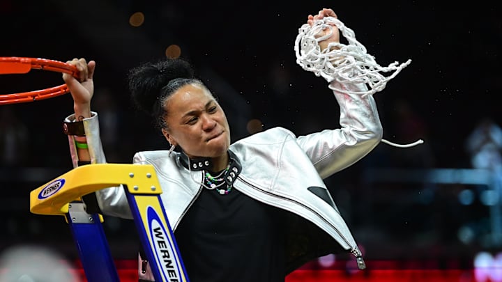 South Carolina basketball coach Dawn Staley cutting down the nets after her third National Championship