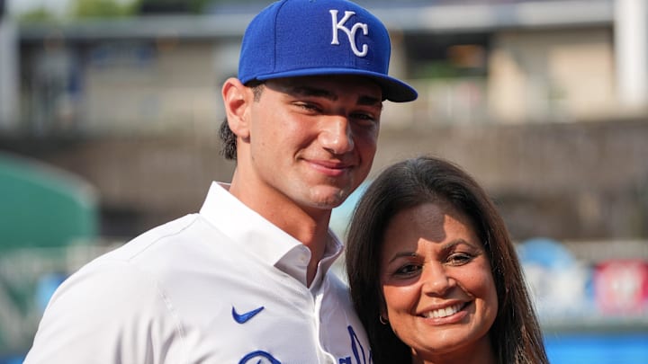 Kansas City Royals first round draft pick Jac Caglianone poses with his mother, Johanne Caglianone, for photos on the field prior to a game against the Arizona Diamondbacks at Kauffman Stadium in 2024.