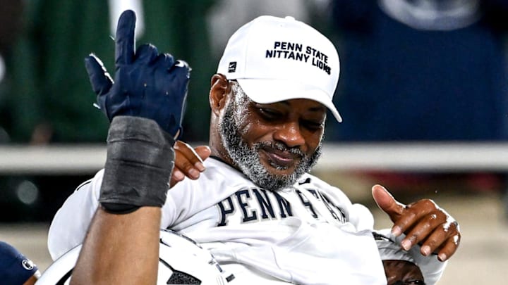 Penn State's interim head coach Terry Smith is carried by players after the game against Michigan State. Penn State's interim head coach Terry Smith is carried by players after the game against Michigan State.