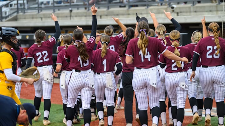 The Southern Illinois softball team celebrates after scoring a run against Mizzou on April 9, 2025.