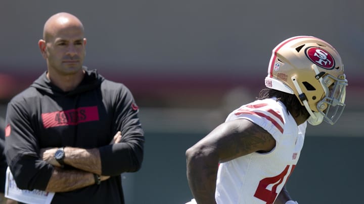San Francisco 49ers defensive coordinator Robert Saleh, left, watches draftee Nick Martin (45)