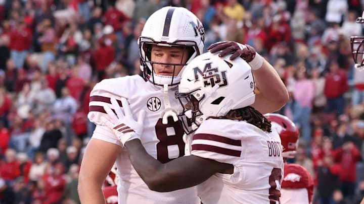 Mississippi State Bulldogs running back Davon Booth (6) celebrates with tight end Sam West (87) after scoring a touchdown in the fourth quarter against the Arkansas Razorbacks at Donald W. Reynolds Razorback Stadium. Bulldogs won 38-35. Mississippi State Bulldogs running back Davon Booth (6) celebrates with tight end Sam West (87) after scoring a touchdown in the fourth quarter against the Arkansas Razorbacks at Donald W. Reynolds Razorback Stadium. Bulldogs won 38-35.