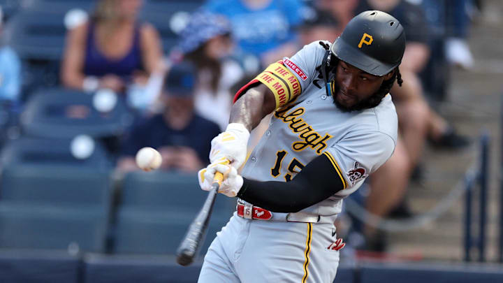 Mar 31, 2025; St. Petersburg, Florida, USA; Pittsburgh Pirates center fielder Oneil Cruz (15) hits a base hit against the Tampa Bay Rays in the first inning at George M. Steinbrenner Field. Mandatory Credit: Nathan Ray Seebeck-Imagn Images