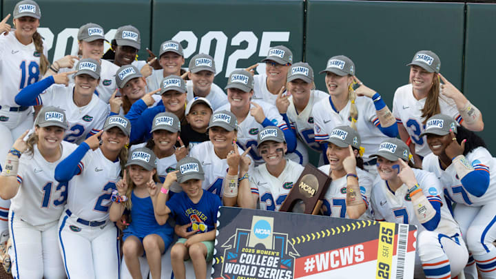 Florida gator pose for photos as they celebrate their 5-2 win over Georgia during the third game of the NCAA super regionals softball game in Gainesville, FL on Sunday, May 25, 2025. Florida goes to the college world series in Oklahoma. [Alan Youngblood/Gainesville Sun]