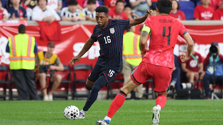 Sep 6, 2025; Harrison, New Jersey, USA; US Men's National Team defender Alex Freeman (16) kicks the ball against South Korea defender Kim Min-Jae (4) during the second half at Sports Illustrated Stadium. Mandatory Credit: Vincent Carchietta-Imagn Images