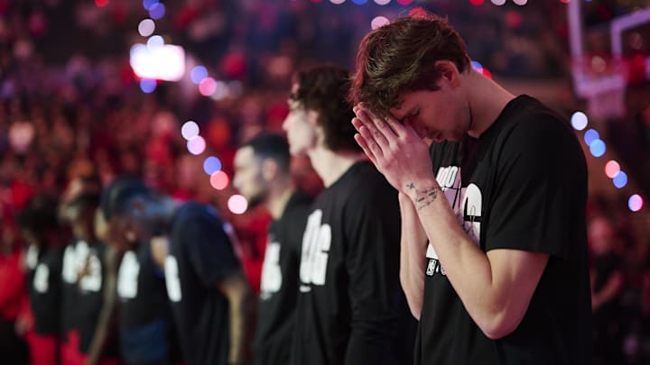Jan 19, 2025; Portland, Oregon, USA; Chicago Bulls forward Matas Buzelis (14) pauses during a silent reflection during the singing of the national anthem before a game against the Portland Trail Blazers at Moda Center. Mandatory Credit: Troy Wayrynen-Imagn Images