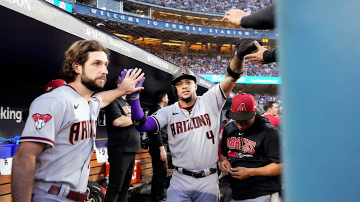 Arizona Diamondbacks starting pitcher Zac Gallen (23) high-fives Ketel Marte (4) after scoring against the Los Angeles Dodgers in the first inning during Game 2 of the NLDS at Dodger Stadium in Los Angeles on Oct. 9, 2023.