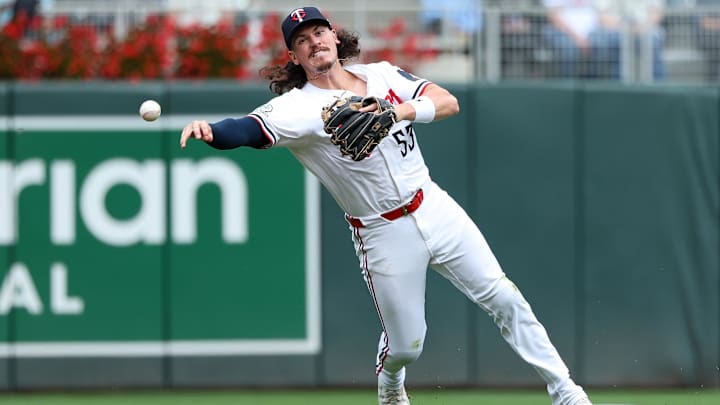 Sep 20, 2025; Minneapolis, Minnesota, USA; Minnesota Twins shortstop Ryan Fitzgerald (53) throws the ball to first base to get out Cleveland Guardians third base and infield coach Rouglas Odor (53) during the fifth inning of game one of a double header at Target Field. Mandatory Credit: Matt Krohn-Imagn Images