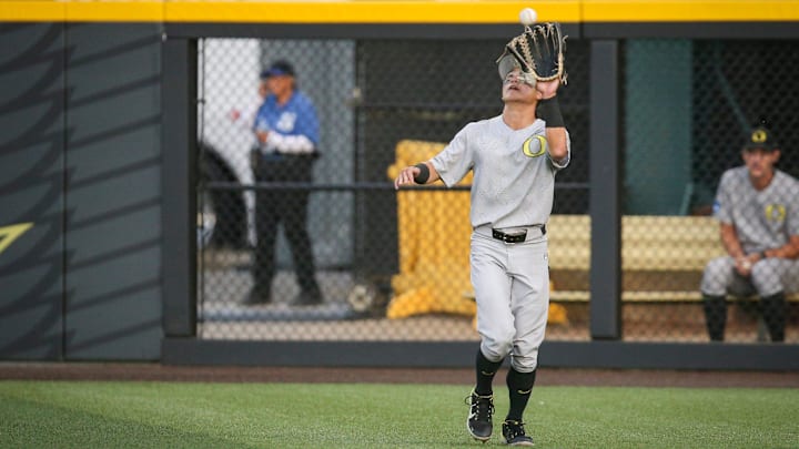 Oregon infielder Rikuu Nishida makes a catch in the outfield in the ninth inning during an NCAA college baseball tournament Super Regional game Saturday, June 10, 2023, in Eugene, Ore. Oral Roberts won 8-7.