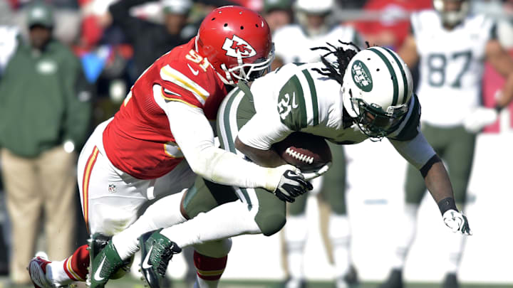 Nov 2, 2014; Kansas City, MO, USA; New York Jets running back Chris Johnson (21) is tackled by Kansas City Chiefs outside linebacker Tamba Hali (91) during the second half at Arrowhead Stadium. The Chiefs won 24-10. Mandatory Credit: Denny Medley-Imagn Images