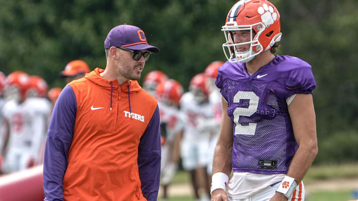 Clemson offensive coordinator Garrett Riley and quarterback Cade Klubnik (2) talk during Clemson football 2025 practice at Jervey Meadows in Clemson, S.C. Wednesday, August 6, 2025.