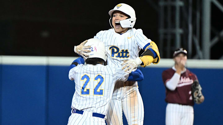 Pitt softball's Kylie Griggs jumps on her teammate after driving in the game-winning run against No. 11 Virginia Tech on Thursday, April 17, 2025.