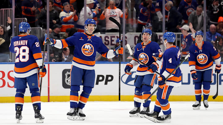 Mar 24, 2025; Elmont, New York, USA; New York Islanders left wing Pierre Engvall (18) celebrates his goal against the Columbus Blue Jackets with defenseman Alexander Romanov (28) and center Casey Cizikas (53) and defenseman Tony DeAngelo (4) during the first period at UBS Arena.