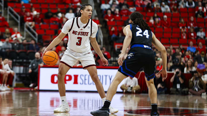 Dec 6, 2025; Raleigh, North Carolina, USA; NC State Wolfpack guard Matt Able (3) dribbles the ball against UNC Asheville Bulldogs guard Corey Jones (24) during the first half of the game at Lenovo Center. Mandatory Credit: Jaylynn Nash-Imagn Images