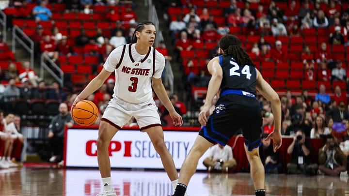 Dec 6, 2025; Raleigh, North Carolina, USA; NC State Wolfpack guard Matt Able (3) dribbles the ball against UNC Asheville Bulldogs guard Corey Jones (24) during the first half of the game at Lenovo Center. Mandatory Credit: Jaylynn Nash-Imagn Images