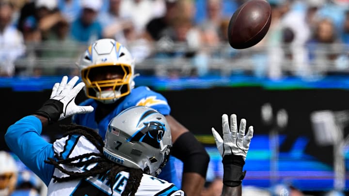 Sep 15, 2024; Charlotte, North Carolina, USA; Carolina Panthers linebacker Jadeveon Clowney (7) reaches for a fumbled ball in the third quarter at Bank of America Stadium. Mandatory Credit: Bob Donnan-Imagn Images