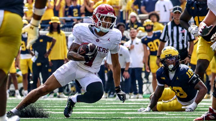 Oklahoma wide receiver Isaiah Sategna catches a pass against Michigan. Oklahoma wide receiver Isaiah Sategna catches a pass against Michigan.
