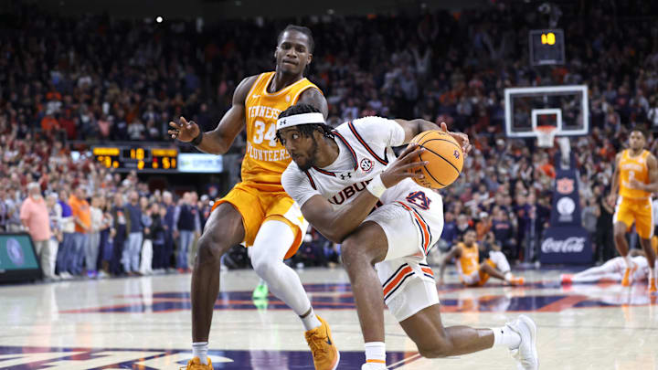 Jan 25, 2025; Auburn, Alabama, USA;  Auburn Tigers forward Chaney Johnson (31) drives against Tennessee Volunteers forward Felix Okpara (34) during the second half at Neville Arena.  Auburn came from behind in the last minute to win the game. Mandatory Credit: John Reed-Imagn Images