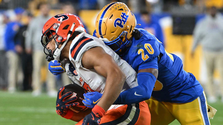Oct 24, 2024; Pittsburgh, Pennsylvania, USA; Pittsburgh Panthers linebacker Jordan Bass (20) tackles Syracuse Orange wide receiver Emanuel Ross (18) during the second quarter at Acrisure Stadium. Mandatory Credit: Barry Reeger-Imagn Images Oct 24, 2024; Pittsburgh, Pennsylvania, USA; Pittsburgh Panthers linebacker Jordan Bass (20) tackles Syracuse Orange wide receiver Emanuel Ross (18) during the second quarter at Acrisure Stadium. Mandatory Credit: Barry Reeger-Imagn Images