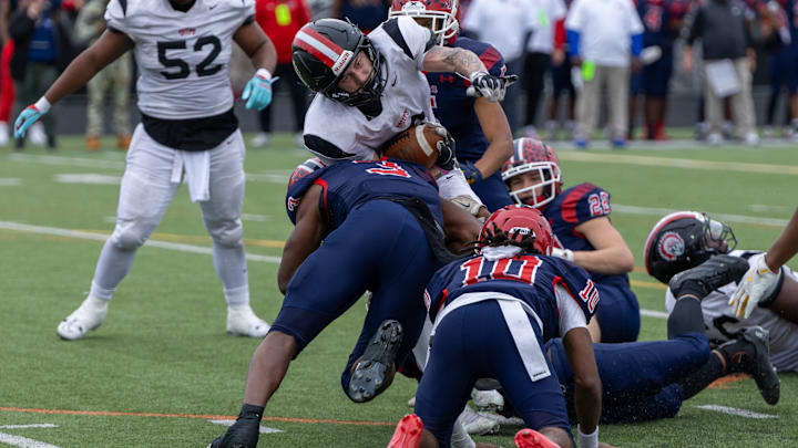 Aliquippa running back JJ Work (6) fights for extra yards while being tackled by McKeesport defensive back Kemon Spell (3) in the second half of the WPIAL Class 4A championship game between Aliquippa and McKeesport Saturday, Nov. 15, 2025 at Pine-Richland Stadium in Gibsonia, Pa.