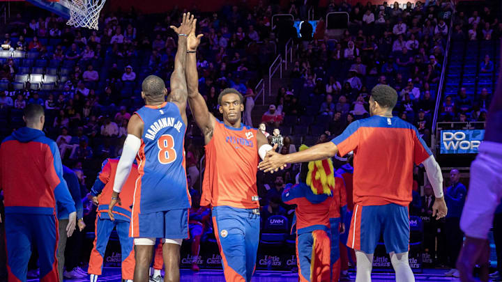 Oct 26, 2024; Detroit, Michigan, USA; Detroit Pistons center Jalen Duren (0) is introduced and hi-fives forward Tim Hardaway Jr. (8) during the in the first half at Little Caesars Arena. Mandatory Credit: David Reginek-Imagn Images