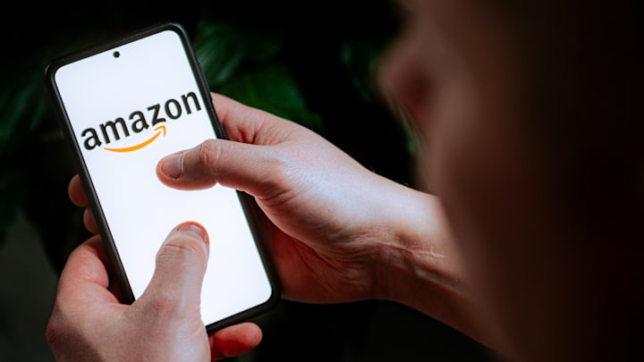 In this photo illustration an Amazon logo seen displayed on...