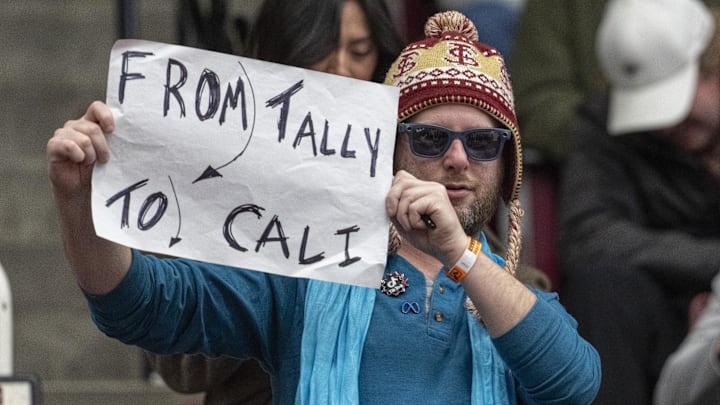 Jan 25, 2025; Stanford, California, USA;  Florida State Seminoles fan holds up a sign during the second half against the Stanford Cardinal at Maples Pavilion. Mandatory Credit: Stan Szeto-Imagn Images