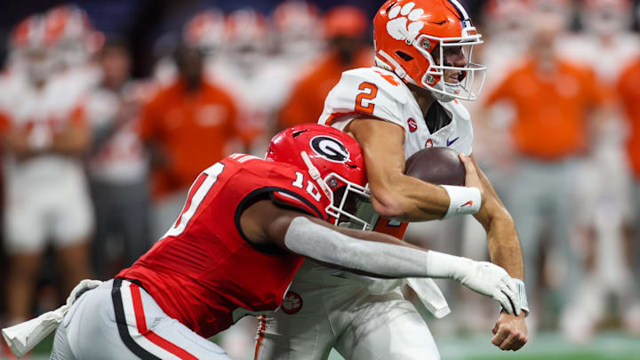 Aug 31, 2024; Atlanta, Georgia, USA; Clemson Tigers quarterback Cade Klubnik (2) is tackled by Georgia Bulldogs linebacker Damon Wilson II (10) in the first quarter at Mercedes-Benz Stadium. Mandatory Credit: Brett Davis-Imagn Images Aug 31, 2024; Atlanta, Georgia, USA; Clemson Tigers quarterback Cade Klubnik (2) is tackled by Georgia Bulldogs linebacker Damon Wilson II (10) in the first quarter at Mercedes-Benz Stadium. Mandatory Credit: Brett Davis-Imagn Images