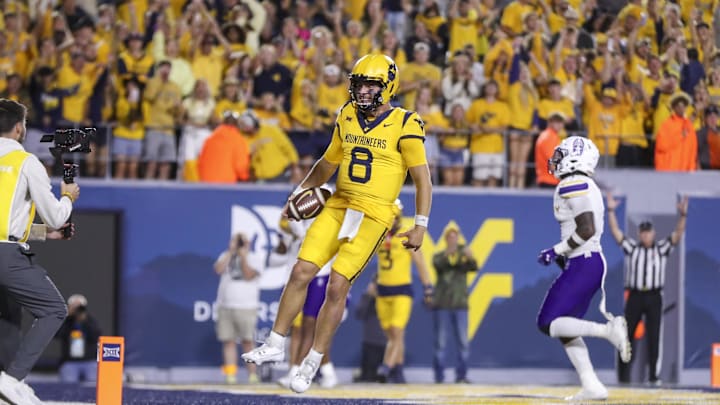Sep 7, 2024; Morgantown, West Virginia, USA; West Virginia Mountaineers quarterback Nicco Marchiol (8) runs the ball for a touchdown during the fourth quarter against the Albany Great Danes at Mountaineer Field at Milan Puskar Stadium. Mandatory Credit: Ben Queen-Imagn Images