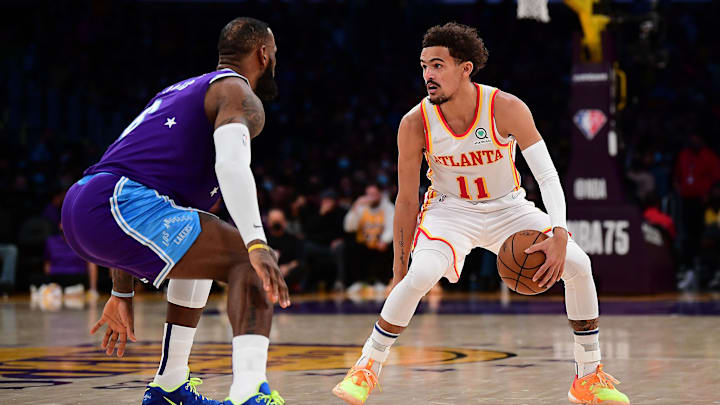 Jan 7, 2022; Los Angeles, California, USA; Atlanta Hawks guard Trae Young (11) controls the ball against Los Angeles Lakers forward LeBron James (6) during the first half at Crypto.com Arena. Mandatory Credit: Gary A. Vasquez-Imagn Images