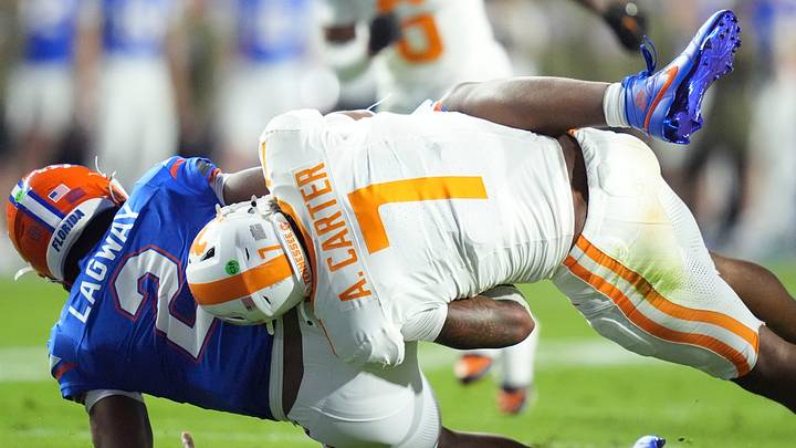 Tennessee linebacker Arion Carter (7) takes down Florida quarterback DJ Lagway (2) in an NCAA college football game on November 22, 2025, in Gainesville, Florida. Tennessee linebacker Arion Carter (7) takes down Florida quarterback DJ Lagway (2) in an NCAA college football game on November 22, 2025, in Gainesville, Florida.